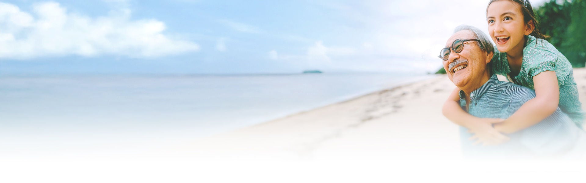 海岸で笑顔の高齢男性と幼い女の子